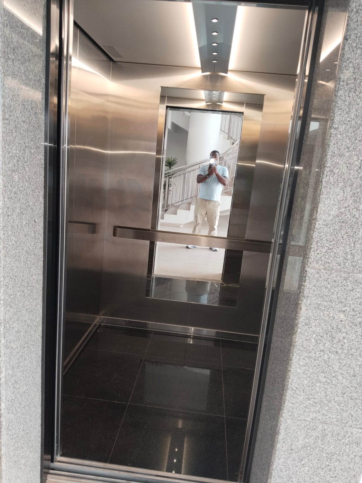 Passenger lift cabin with stainless steel finishes